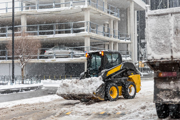 Machine remove snow from a city street