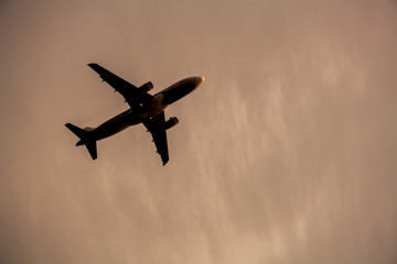 Fototapeta na wymiar Airplane take off silhouette with sunlight in background.