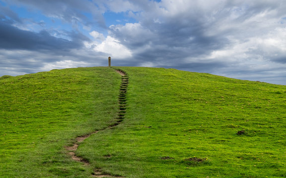 small path leading up a green hill