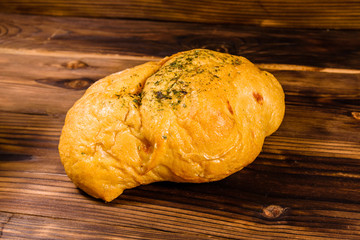 Italian bun ciabatta with garlic on wooden table