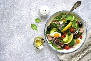 Tuna salad with mix salad leaves (spinach and arugula) , avocado, cherry tomato, cucumber and egg.Top view.