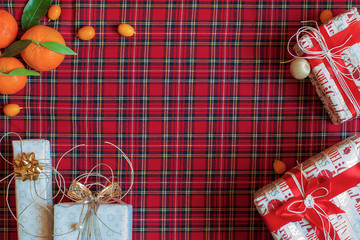 New Year's gifts and Christmas decorations on the background of Scottish cloth