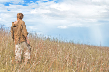 man dressed as a medieval peasant in the field