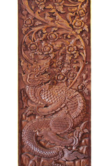 wooden carving sculpture of mystery dragon in the middle of heaven forest isolated on white backgrounds, home decoration, thai culture 