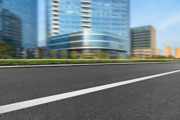Obraz premium city empty traffic road with cityscape in background.