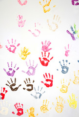 Colorful hand prints on the white wall