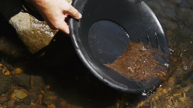 close up of washing gravel from a gold pan