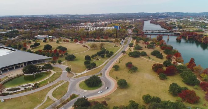 A high angle aerial flyover of Vic Mathias Shores At Town Lake Metro Park on the shore of the Colorado River in downtown Austin, Texas.  	