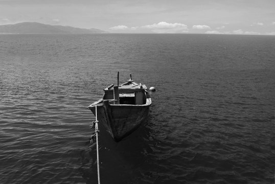 Fototapeta Old wooden boat in the sea. Vietnam. Black and white