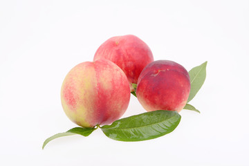 A few fresh peach on a white background