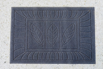 Old and grunge foot scraper or doormat on floor.