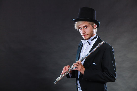 Elegantly dressed musician holding flute