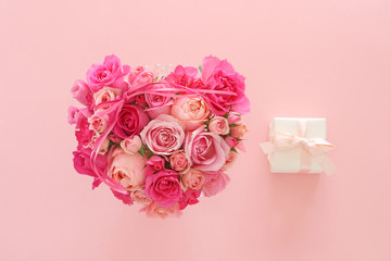 Valentine background.  Heart shaped  bouquet of beautiful pink rose flowers with heart ornaments