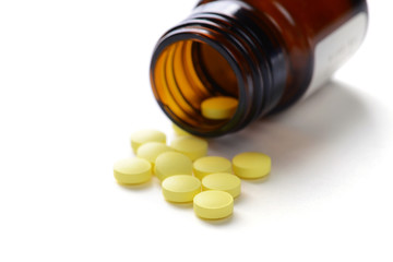 Pills with bottle on white background