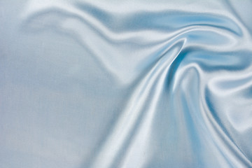 Texture of natural satin or silk cloth of blue colour for festive backgrounds