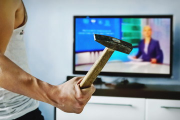 Exasperated the young man the bad news breaks the TV