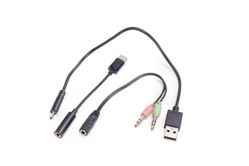 Different audio and USB cables on a white background