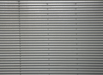 Fototapeta premium Corrugated metal wall, detail of a wall lined with metal, shiny steel
