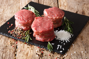 fresh raw beef fillet mignon on old wooden background. Horizontal