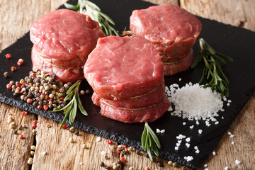fresh raw beef filet mignon with spices cut ready to cook close up. horizontal