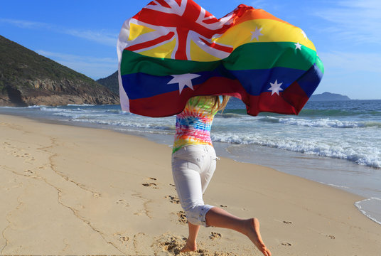 Marriage Equality  Joyous woman running along the beach with a r