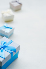 Boy gift on Valentine's Day. Lovely surprise. Blue festive present boxes on white background. Copyspace concept