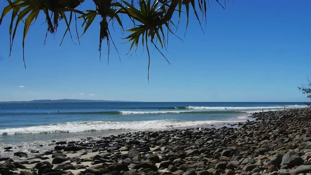 surfers ride waves at the famous point break at noosa heads in queensland, australia