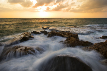 Seascape at Hang Rai Beach. Nui Chua national park, Ninh Thuan, Viet Nam, waves on large rock and make amazing fall in Hang Rai at sunrise