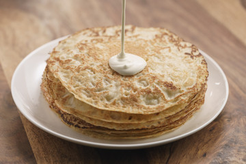 cream pour on freshly made blinis or crepes, simple sweet food