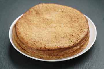 homemade crepes on plate on slate board