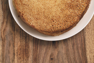 homemade crepes on plate on wood table