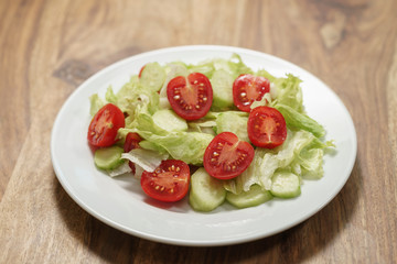 vegetable salad with tomato, cucumber and iceberg lettuce