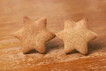 Two stars. Gingerbread Cookie. Brown background