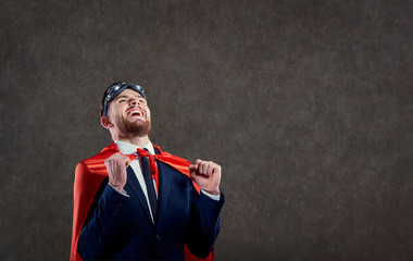 A man in a superhero costume with positive emotions in place for text.