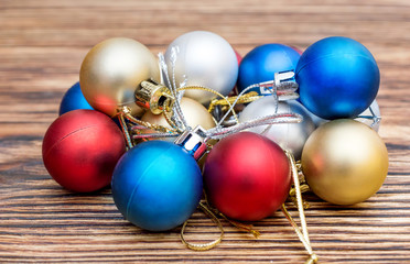 Heap of Christmas balls on wooden table. New year background.