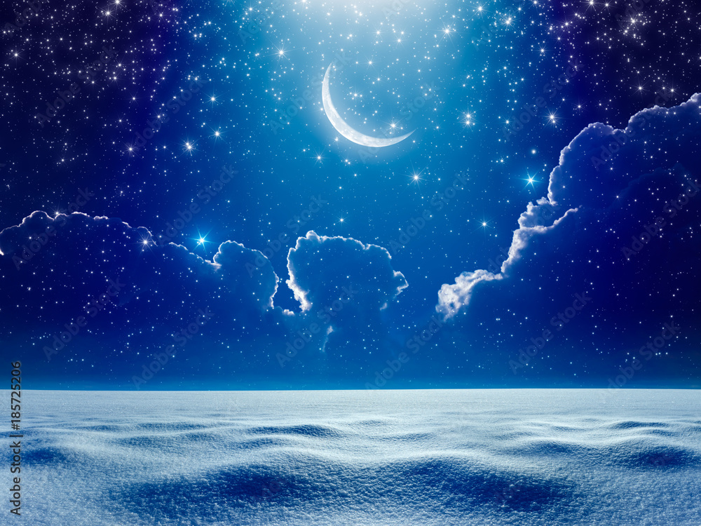 Wall mural crescent moon in dark blue night starry sky above snowy field, bright blue spotlight from skies