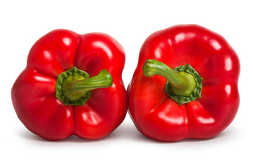 Two red sweet peppers isolated