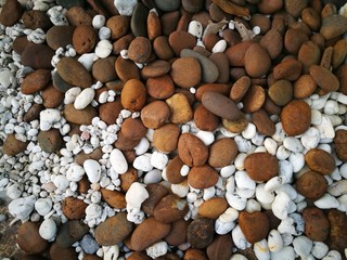 Mixed small brown and white stones texture. Useful as background for website, floor mat or decoration in architectural design.