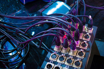 black microphone cables connected to the sound mixer