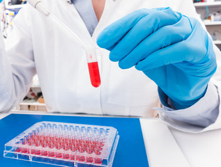 technician woman works with in genetic lab with biological materials