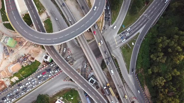 top down aerial view of traffic on freeway interchange at Kuala-Lumpur