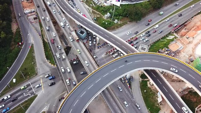 top down aerial view of traffic on freeway interchange at Kuala-Lumpur