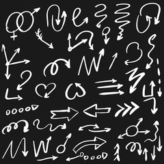 Arrow doodles vector. A set of simple sketches of arrows. Up, down, left, right. The pencil sketch effect, isolated white arrows on a black background. Vector eps 10.