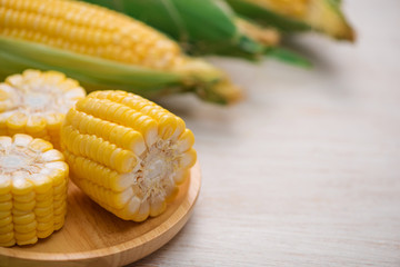 Sweet corns. Fresh corn on cobs on wooden table.