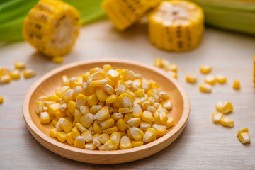 Sweet corn seeds on a wooden plate