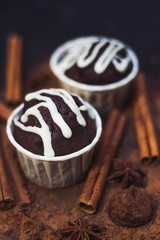 homemade spicy chocolate cupcake , sweets and spices mess on the table