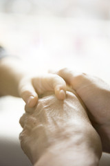 The mother is holding the hand of the baby. Mother's and baby's hands. Family concept 