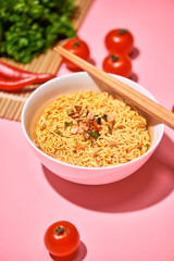A Bowl of instant noodles on wooden table