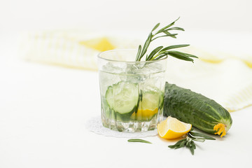 Drink of chopped cucumber and rosemary on white background