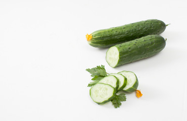 Fresh sliced cucumber with parsley on white background